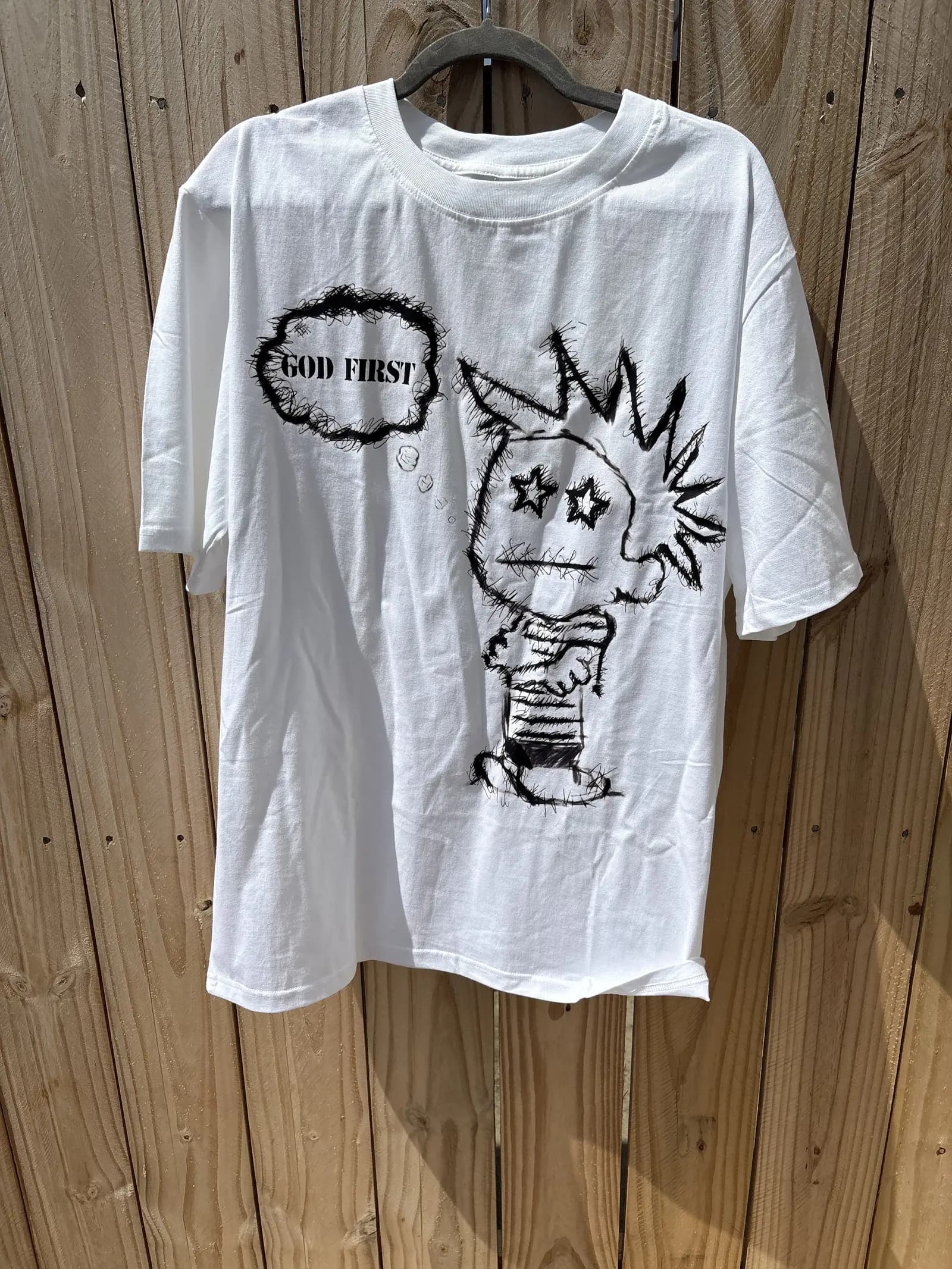 Child of God tee hanging outdoors